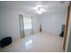 An empty bedroom featuring neutral tones, tiled floors, and plenty of natural light at 956 Florida Pkwy, Kissimmee, FL 34743