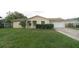 Charming single-story home with a well-maintained lawn and a two-car garage at 956 Florida Pkwy, Kissimmee, FL 34743