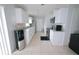 Bright kitchen with white cabinets, stainless steel appliances, and tile floors at 956 Florida Pkwy, Kissimmee, FL 34743
