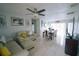 Inviting living room with tile flooring and neutral tones, seamlessly flowing into the dining area at 956 Florida Pkwy, Kissimmee, FL 34743