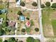 Aerial view of a home on a large lot with mature trees, adjacent to a road and neighboring residences at 1 Coyer Rd, Haines City, FL 33844