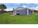 Home exterior showcasing a large yard and back patio perfect for outdoor living at 1 Coyer Rd, Haines City, FL 33844