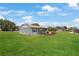 Expansive backyard with a covered deck, ideal for entertaining and enjoying the outdoors at 1 Coyer Rd, Haines City, FL 33844