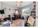Cozy bedroom with natural light, wood-look floors, ceiling fan, and a neutral color palette at 1 Coyer Rd, Haines City, FL 33844