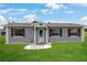 Charming single-story home featuring a well-manicured lawn and decorative stone landscaping at 1 Coyer Rd, Haines City, FL 33844