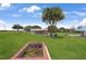 Expansive front yard with a charming single-story home and mature trees provides a serene outdoor living space at 1 Coyer Rd, Haines City, FL 33844