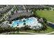 Aerial view of a community pool featuring a splash pad and plenty of lounge seating at 11051 Bostwick Aly, Winter Garden, FL 34787
