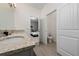 Bathroom featuring granite countertops and neutral-toned tile flooring at 11051 Bostwick Aly, Winter Garden, FL 34787