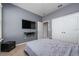Neutral bedroom with a plush bed, mounted TV, and a closet with white doors at 11051 Bostwick Aly, Winter Garden, FL 34787
