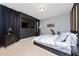 Stylish bedroom showcasing dark accents, exercise bike, and a comfortable bed at 11051 Bostwick Aly, Winter Garden, FL 34787