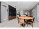 Open dining area with a wood table, stylish chairs, and a built-in wine rack feature at 11051 Bostwick Aly, Winter Garden, FL 34787