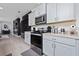 Modern kitchen with stainless steel appliances, light gray cabinetry, and granite countertops at 11051 Bostwick Aly, Winter Garden, FL 34787