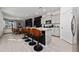 Open-concept kitchen with gray cabinets, granite countertops, and a large island with bar seating at 11051 Bostwick Aly, Winter Garden, FL 34787