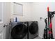 Laundry room with stainless steel washer and dryer and plenty of room for storage at 11051 Bostwick Aly, Winter Garden, FL 34787