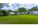 Green backyard showing the fence line and exterior of neighboring houses at 113 W Division St, Winter Garden, FL 34787