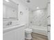 Modern bathroom with marble tile, new vanity, stainless steel fixtures, and shower at 113 W Division St, Winter Garden, FL 34787