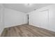 Bright bedroom with new laminate flooring, white walls, a double door closet and a ceiling light at 113 W Division St, Winter Garden, FL 34787