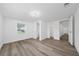 Bedroom with new laminate flooring, white walls, and doorway to the bathroom and closet at 113 W Division St, Winter Garden, FL 34787
