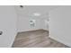 Bright bedroom with new laminate flooring, white walls, and two windows at 113 W Division St, Winter Garden, FL 34787