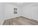 Well-lit bedroom with new laminate flooring, white walls, window, and a double door closet at 113 W Division St, Winter Garden, FL 34787