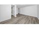 Spacious bedroom featuring new laminate flooring, white walls, and doorway to the bathroom at 113 W Division St, Winter Garden, FL 34787