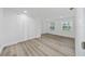 Spacious bedroom featuring new laminate flooring, double door closet and bright windows at 113 W Division St, Winter Garden, FL 34787