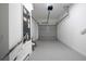 A spacious two-car garage with neutral walls and flooring, ideal for parking and storage at 113 W Division St, Winter Garden, FL 34787