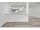 Bright eat-in kitchen with breakfast bar, stainless appliances, and new vinyl plank flooring at 113 W Division St, Winter Garden, FL 34787