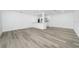 Bright open living space with new vinyl floors flowing into the adjacent eat-in kitchen area at 113 W Division St, Winter Garden, FL 34787