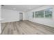 Bright living room with large window and new vinyl flooring provides a cozy atmosphere at 113 W Division St, Winter Garden, FL 34787