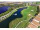 Scenic aerial view of a golf course, lakes and community with fountains and lush landscaping at 1173 Trappers Trail Loop, Champions Gate, FL 33896