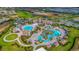 Aerial view of community amenities including pool, clubhouse and lush landscaping at 1173 Trappers Trail Loop, Champions Gate, FL 33896