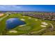 Aerial view of golf course and lake bordering a new construction neighborhood at 1173 Trappers Trail Loop, Champions Gate, FL 33896