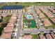 Aerial view of neighborhood pool, playground and homes on a sunny day at 1173 Trappers Trail Loop, Champions Gate, FL 33896