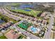 Aerial view of the neighborhood, showing the community's pool and playground on a sunny day at 1173 Trappers Trail Loop, Champions Gate, FL 33896