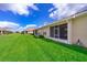 Spacious backyard with green grass, manicured landscaping, and views of neighboring homes at 1173 Trappers Trail Loop, Champions Gate, FL 33896