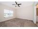 Cozy bedroom with carpet flooring, ceiling fan, and bright window at 1173 Trappers Trail Loop, Champions Gate, FL 33896