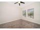 Cozy bedroom with carpet, a ceiling fan, and natural light from the two windows at 1173 Trappers Trail Loop, Champions Gate, FL 33896