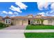 Charming home featuring a tile roof, two-car garage, and manicured landscaping at 1173 Trappers Trail Loop, Champions Gate, FL 33896