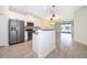Modern kitchen with stainless steel appliances, white cabinets, and an island counter at 1173 Trappers Trail Loop, Champions Gate, FL 33896