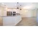 Bright kitchen with white cabinetry, stainless appliances, and open layout at 1173 Trappers Trail Loop, Champions Gate, FL 33896