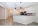 Open-concept kitchen with a breakfast bar, stainless steel appliances, and tile flooring at 1173 Trappers Trail Loop, Champions Gate, FL 33896