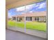 View of a well-maintained backyard with lush green lawn and exterior of home from screened in lanai at 1173 Trappers Trail Loop, Champions Gate, FL 33896