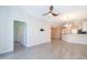 Open living area with tile flooring leading to the kitchen and dining area at 1173 Trappers Trail Loop, Champions Gate, FL 33896