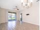 Spacious living room with tile flooring and sliding glass doors to the screened lanai at 1173 Trappers Trail Loop, Champions Gate, FL 33896