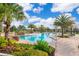Community pool area with lush landscaping, comfortable lounge chairs, and a relaxing atmosphere at 1173 Trappers Trail Loop, Champions Gate, FL 33896