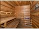 Relaxing sauna room featuring wood paneling, built-in benches, and a heater at 1173 Trappers Trail Loop, Champions Gate, FL 33896