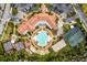 Stunning aerial view of community pool, clubhouse, and tennis courts; resort-style living at its finest at 125 Prima Dr, Poinciana, FL 34759
