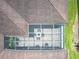 An aerial view of a home showing the layout of the backyard patio, roof and manicured lawn at 125 Prima Dr, Poinciana, FL 34759