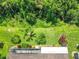 Aerial view of backyard with lush landscaping and mature trees offering privacy at 125 Prima Dr, Poinciana, FL 34759